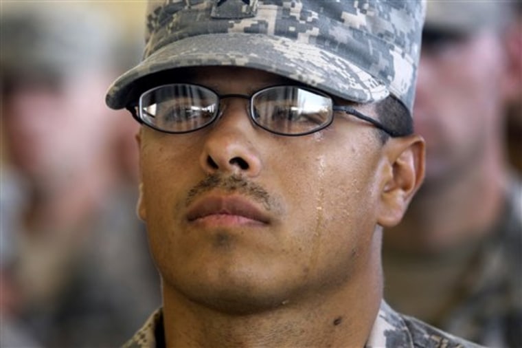 An unidentified U.S. army soldier from 1st Squadron, 7th U.S. Cavalry Regiment based in Ft. Hood Texas reacts during a memorial service in memory of those who died in the Sept. 11, 2001 terrorist attacks at a U.S. base in Balad, Iraq, on Sunday, Sept. 11. US soldiers based in Iraq took part in a special remembrance ceremony on Sunday for the 10th anniversary of the attacks. 
